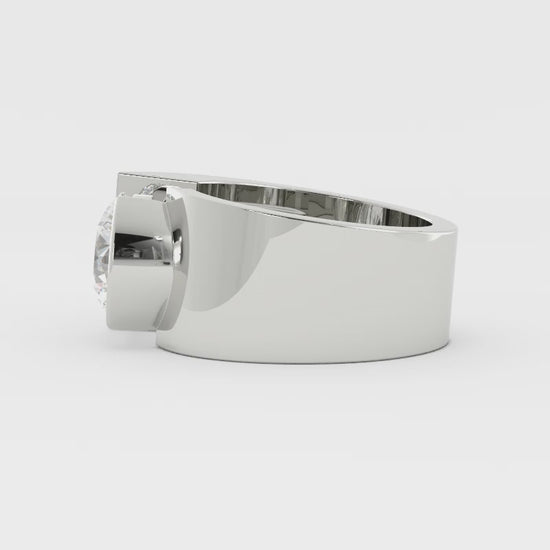 Video of a wide silver ring with a bezel-set diamond rotating on a white background