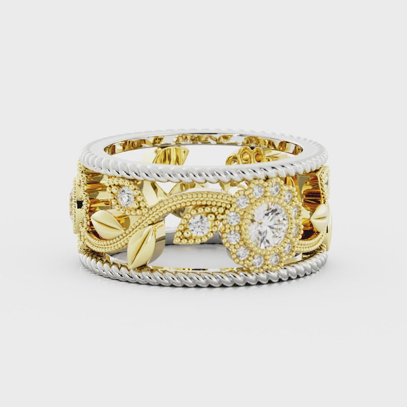 Video of a wide gold and silver ring band with an ornate diamond floral design rotating on a white background