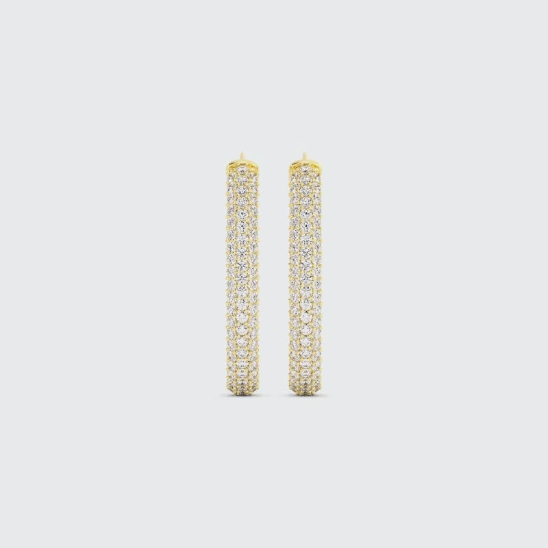 Video of gold drop earrings covered in pave diamonds on a white background
