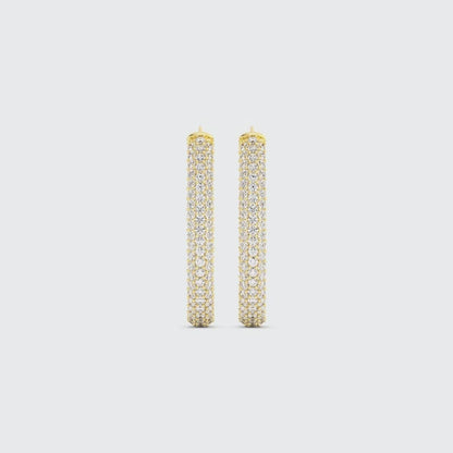 Video of gold drop earrings covered in pave diamonds on a white background